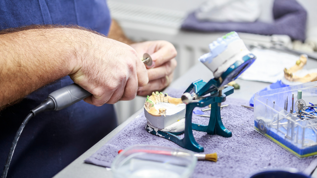Dental lab technician working on a dental restoration